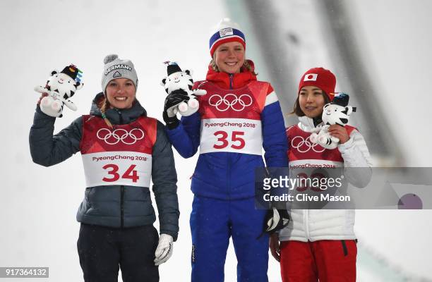 Silver medalist Katharina Althaus of Germany, gold medalist Maren Lundby of Norway and bronze medalist Sara Takanashi of Japan stand on the podium...