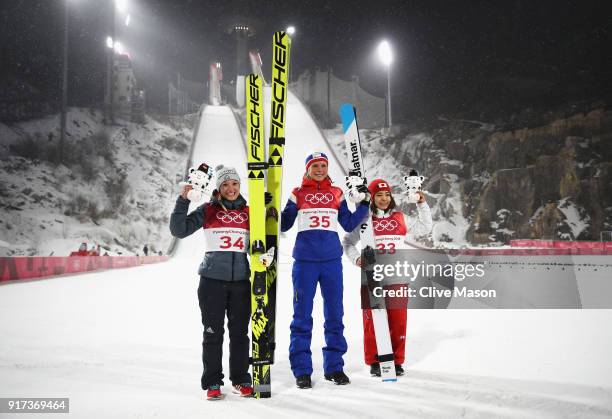 Silver medalist Katharina Althaus of Germany, gold medalist Maren Lundby of Norway and bronze medalist Sara Takanashi of Japan celebrate after the...