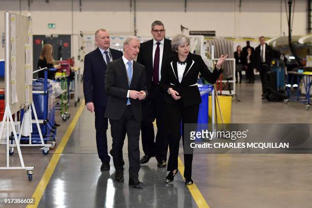 British Prime Minister Theresa May speaks to Michael Ryan , president of Bombardier Aerostructures and Engineering services division, during a visit...