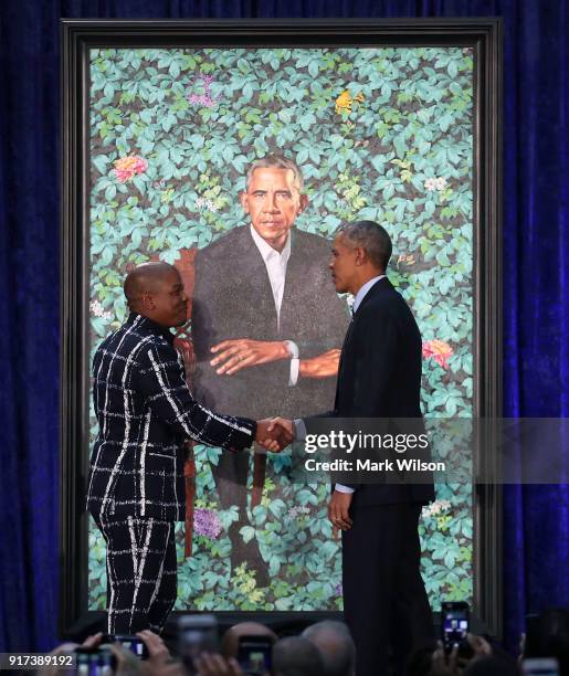 Former U.S. President Barack Obama stands artist Kehinde Wiley next to his newly unveiled portrait during a ceremony at the Smithsonian's National...