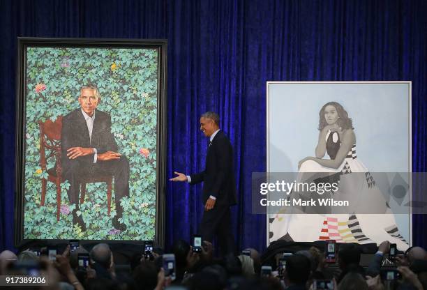 Former U.S. President Barack Obama stands with his and former first lady Michelle Obama's newly unveiled portrait during a ceremony at the...