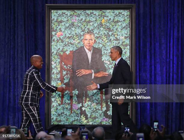 Former U.S. President Barack Obama stands artist Kehinde Wiley next to his newly unveiled portrait during a ceremony at the Smithsonian's National...