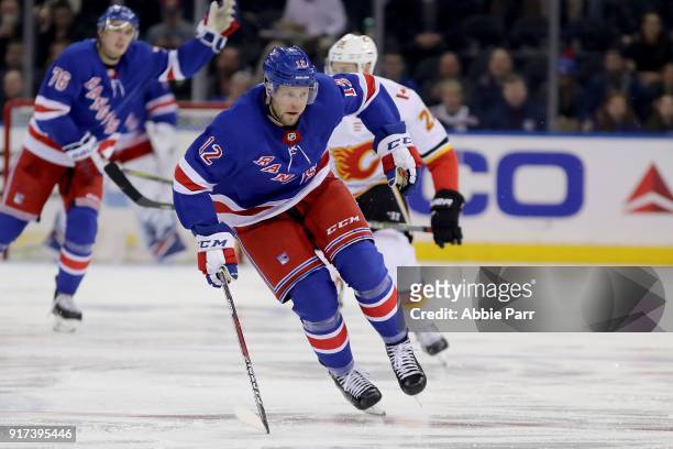 Peter Holland of the New York Rangers chases the puck in the second period against the Calgary Flames during their game at Madison Square Garden on...