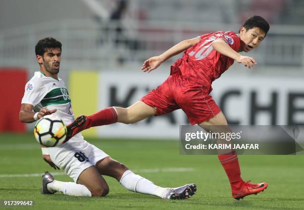 Qatar's Al-Duhail Nam Tae-hee vies for the ball against Iranian Zobahan club's Hamid Bou Hamdan during their AFC Champions League match between...