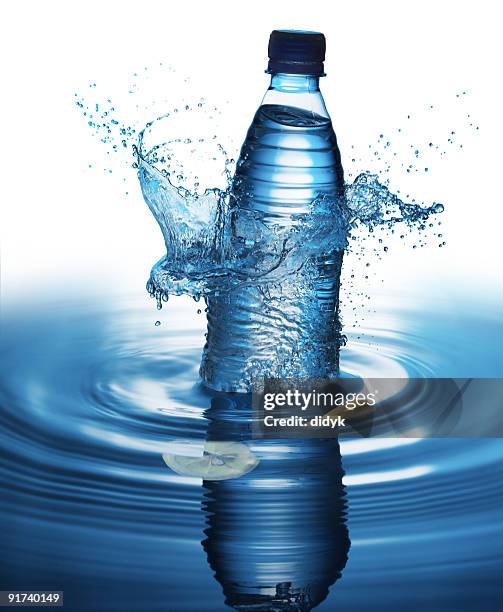 water bottle splashing into a pool of water - water bottle splash stock pictures, royalty-free photos & images