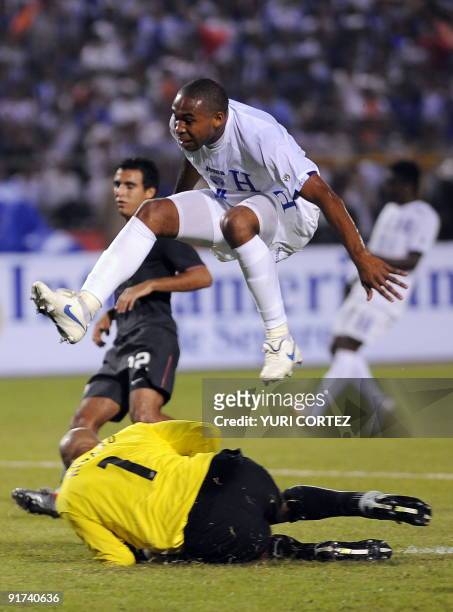 Honduran Wilson Palacios jumps over US goalkeeper Tim Howard during their FIFA World Cup South Africa 2010 Concacaf qualifier football match at...