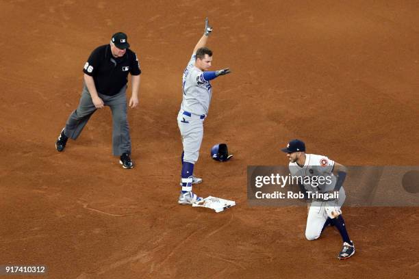 Joc Pederson of the Los Angeles Dodgers slides safely into second base with a double as Carlos Correa of the Houston Astros applies the tag in the...