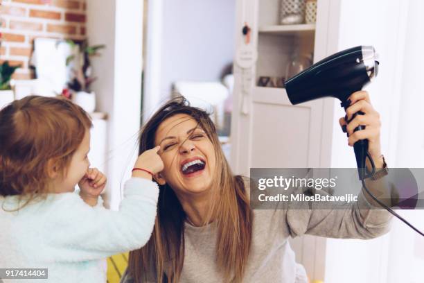 madre e hija poco divertirse - hair dryer fotografías e imágenes de stock