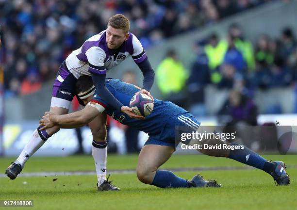 Finn Russell of Scotland is tackled by Guilhem Guirado during the Six Nations match between Scotland and France at Murrayfield on February 11, 2018...