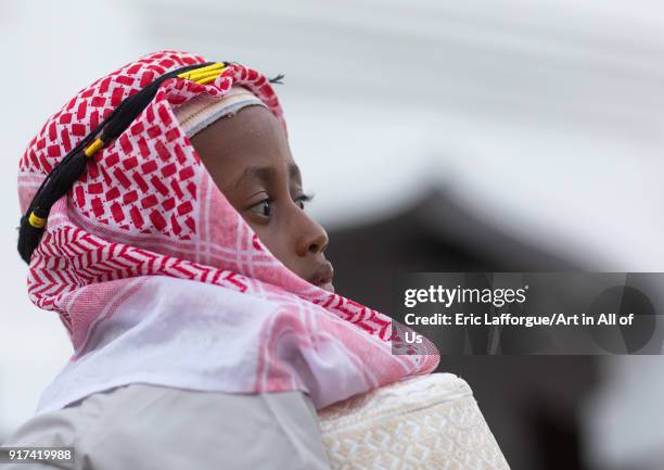 Sunni muslim boy dressed with a keffieh for the Maulidi festivities, Lamu County, Lamu Town, Kenya on December 16, 2017 in Lamu Town, Kenya.