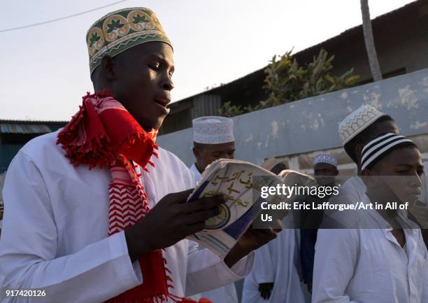 Sunni muslim man reading a religious book during the Maulidi festivities in the street, Lamu County, Lamu Town, Kenya on January 1, 2012 in Lamu...