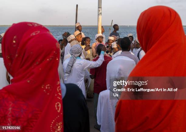 Sunni muslim men dancing during the Maulidi festivities in the street, Lamu County, Lamu Town, Kenya on January 1, 2012 in Lamu Town, Kenya.