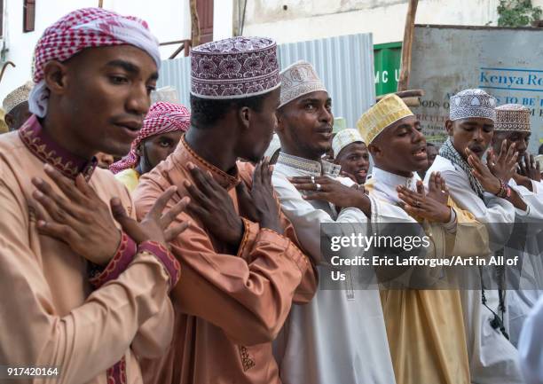 Sunni muslim men dancing during the Maulidi festivities in the street, Lamu County, Lamu Town, Kenya on January 1, 2012 in Lamu Town, Kenya.