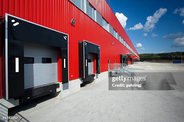 red metal facade on modern warehousing unit - warehouse exterior stock pictures, royalty-free photos & images