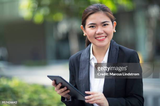 woman outdoors with a tablet - philippines women stock pictures, royalty-free photos & images