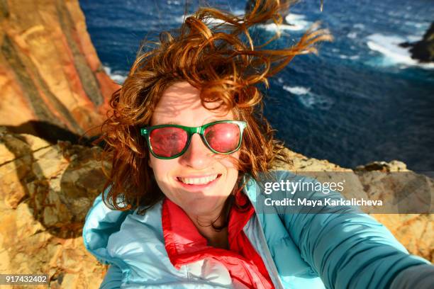 caucasian woman with sunglasses taking selfie at madeira island, atlantic ocean, portugal - unvollkommenheit stock-fotos und bilder