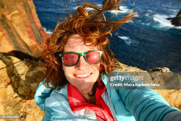 caucasian woman with sunglasses taking selfie at madeira island, atlantic ocean, portugal - imperfection stock pictures, royalty-free photos & images