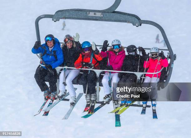 King Philippe of Belgium, Queen Mathilde of Belgium, Prince Gabriel, Princess Elisabeth, Prince Emmanuel and Princess Eleonore wave from a ski lift...