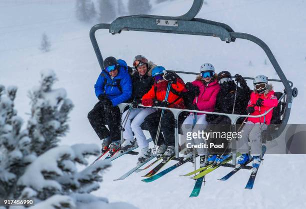 King Philippe of Belgium, Queen Mathilde of Belgium, Prince Gabriel, Princess Elisabeth, Prince Emmanuel and Princess Eleonore wave from a ski lift...