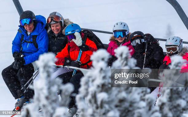 King Philippe of Belgium, Queen Mathilde of Belgium, Prince Gabriel, Princess Elisabeth, Prince Emmanuel and Princess Eleonore wave from a ski lift...