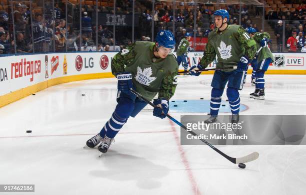 Auston Matthews of the Toronto Maple Leafs skates while wearing a camouflage jersey to honour the Canadian Armed Forces during warm up before playing...