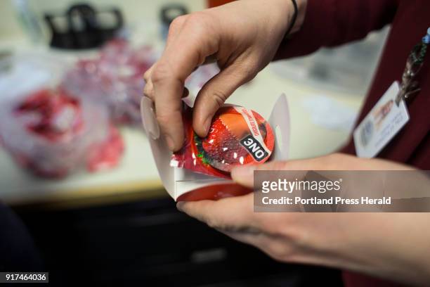 Lizzy Garnatz, a community health promotion specialist, packages Valentine's Day themed condoms at the STD free clinic on Thursday, Feb. 1, 2018 at...
