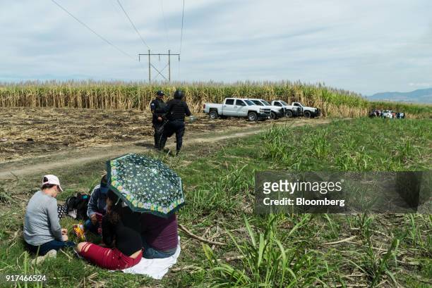 Members of the 'United Families,' a local non-government organization founded last year to locate missing relatives, wait for information at the site...