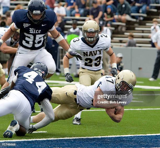 Fullback Vince Murray of Navy dives for a touchdown past defensive back Chris Jones of Rice at Rice Stadium on October 10, 2009 in Houston, Texas.