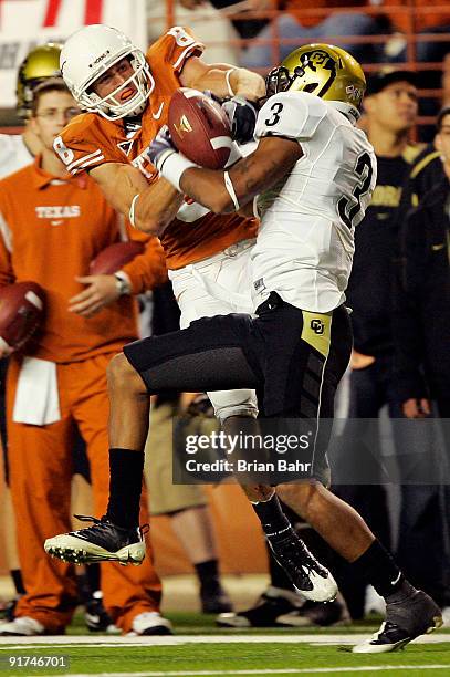 Jordan Shipley of the Texas Longhorns wrestles for control of the ball with cornerback Jimmy Smith of the Colorado Buffaloes for an incomplete pass...