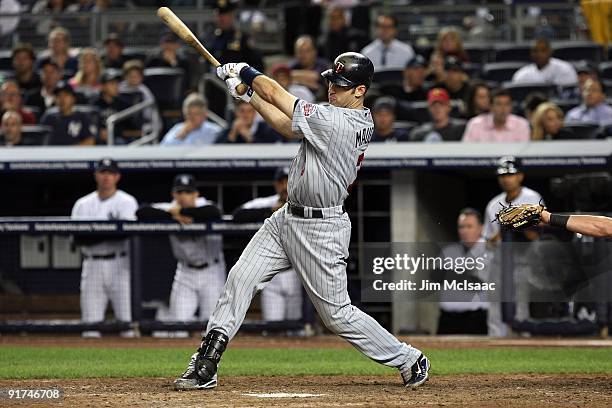 Joe Mauer of the Minnesota Twins hits a eleventh inning single against the New York Yankees in Game Two of the ALDS during the 2009 MLB Playoffs at...