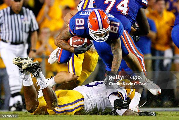 Aaron Hernandez of the Florida Gators leaps over top of Chad Jones of the Louisiana State University Tigers at Tiger Stadium on October 10, 2009 in...
