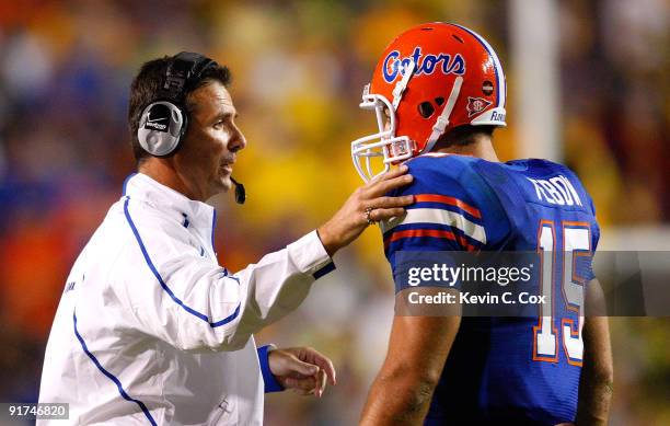 Head coach Urban Meyer talks with quarterback Tim Tebow of the Florida Gators during the game against the Louisiana State University Tigers at Tiger...