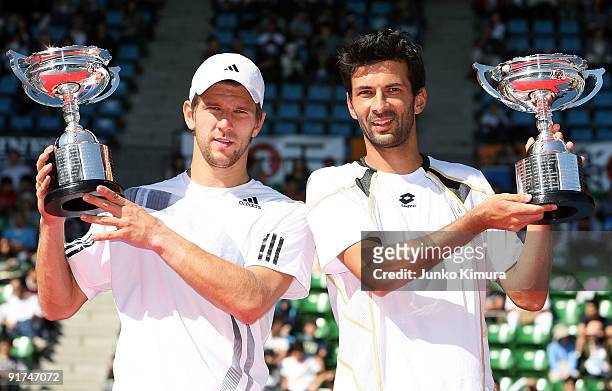 Julian Knowle and Jurgen Melzer of Austria hold their trophies after victory in their doubles match against Ross Hutchins of Great Britain and Jordan...