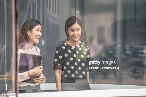 asian female friends walking together - transparent blouse stock pictures, royalty-free photos & images