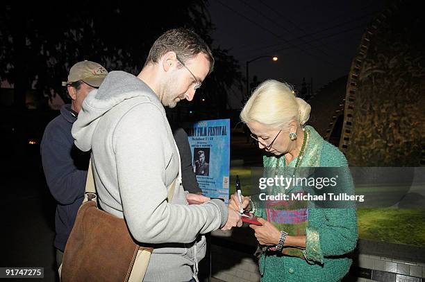 Actress France Nuyen signs an autograph for a fan at the 2009 Backlot Film Festival on October 10, 2009 in Culver City, California.