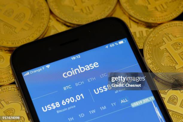 In this photo illustration, the Coinbase cryptocurrency exchange application is seen on the screen of an iPhone on February 12, 2018 in Paris,...