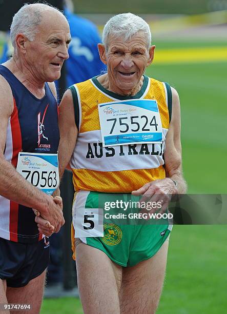 Australia's Osmo Millridge is congratulated by a fellow competitor after completing his race in the 75-79 age group steeple-chase during the World...