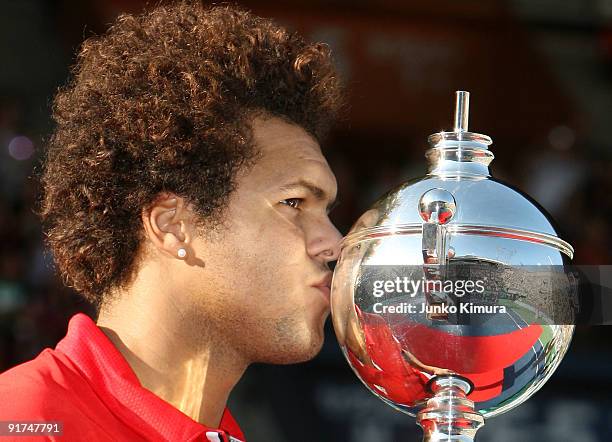 Jo-Wilfried Tsonga of France kisses the trophy after winning the final match against Mikhail Youzhny of Russia during day seven of the Rakuten Open...