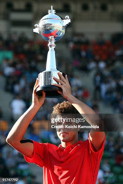 Jo-Wilfried Tsonga of France holds the winners trophy after winning against Mikhail Youzhny of Russia in the Men's Singles Final match against during...