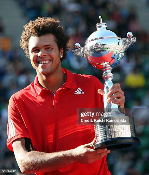 Jo-Wilfried Tsonga of France holds the winners trophy after winning against Mikhail Youzhny of Russia in the Men's Singles Final match against during...