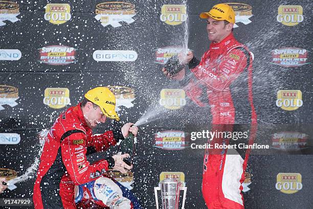 Garth Tander and Will Davison drivers of the Holden Racing Team Holden celebrate on the podium after winning the Bathurst 1000, which is round 10 of...