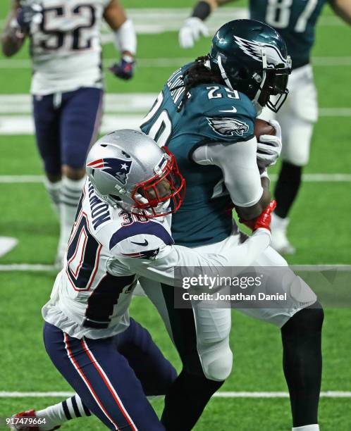 Duron Harmon of the New England Patriots tries to bring down LeGarrette Blount of the Philadelphia Eagles during Super Bowl Lll at U.S. Bank Stadium...