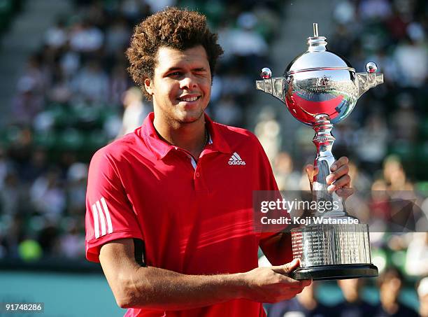 Jo-Wilfried Tsonga of France holds up the winner's trophy up during the awards ceremony after his victory over Mikhail Youzhny of Russia Mikhail...