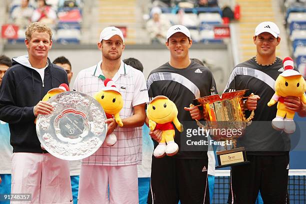 Bob Bryan and Mike Bryan of USA, Mark Knowles of Bahamas and Andy Roddick of USA pose with the trophies after the men's double final match during day...