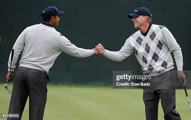 Tiger Woods, left, and Steve Stricker, right, of the U.S. Team celebrate on the 12th green during the day three afternoon Fourball Matches of The...