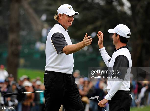 Ernie Els, left, and Mike Weir, right, of the International Team celebrate at the 11th green during the day three afternoon Fourball Matches of The...