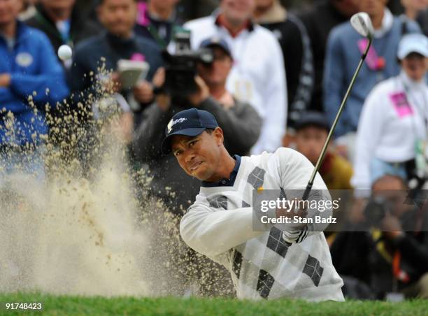 Tiger Woods of the U.S. Team hits onto a green during the day three afternoon Fourball Matches of The Presidents Cup at Harding Park Golf Club on...