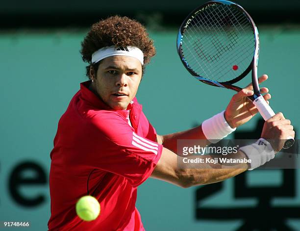 Jo-Wilfried Tsonga of France plays a backhand in the Men's Singles Final match against Mikhail Youzhny of Russia during day seven of the Rakuten Open...