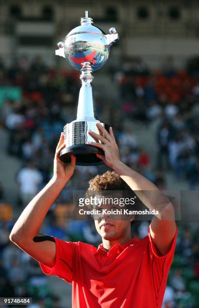 Jo-Wilfried Tsonga of France holds the winners trophy after winning against Mikhail Youzhny of Russia in the Men's Singles Final during day seven of...