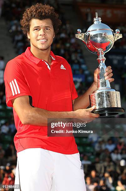 Jo-Wilfried Tsonga of France holds the trophy after winning the men's singles final match against Mikhail Youzhny of Russia during day seven of the...
